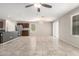 Bright open-concept living space features tile floors, a ceiling fan, and kitchen with stainless appliances at 5113 E Greenway E St, Mesa, AZ 85205