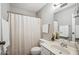 Well-lit bathroom with a vanity, toilet, and shower with a clean, white shower curtain at 520 N Stapley Dr # 134, Mesa, AZ 85203
