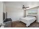 Cozy bedroom with neutral walls, carpet flooring, ceiling fan, and a bright window at 520 N Stapley Dr # 134, Mesa, AZ 85203