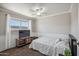 Bright bedroom with a ceiling fan, and a large window providing natural light at 520 N Stapley Dr # 134, Mesa, AZ 85203