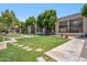 Well-maintained community grounds feature lush green lawns, mature trees, and convenient access to residential buildings at 520 N Stapley Dr # 134, Mesa, AZ 85203