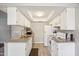 Traditional-style kitchen with tiled floors, white appliances, and ample storage at 520 N Stapley Dr # 134, Mesa, AZ 85203