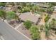 Bird's eye view of the property with a lush yard, mature trees, and convenient street access at 6102 E Aster Dr, Scottsdale, AZ 85254