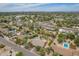 Expansive aerial view showcasing homes with pools, lush greenery, and distant mountain views in a vibrant community at 6102 E Aster Dr, Scottsdale, AZ 85254