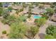 A beautiful aerial view of the property featuring a pool, lawn, trees, and an outdoor entertainment area at 6102 E Aster Dr, Scottsdale, AZ 85254