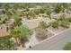 Overhead shot of the house with a well-maintained lawn, mature trees, and desert landscaping at 6102 E Aster Dr, Scottsdale, AZ 85254