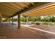 Spacious covered patio overlooking the backyard, providing shade and an outdoor living space with pool views at 6102 E Aster Dr, Scottsdale, AZ 85254