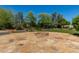 Outdoor fire pit on a stone patio surrounded by a grassy lawn and mature trees, great for entertaining at 6102 E Aster Dr, Scottsdale, AZ 85254