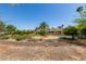 Expansive backyard with a pool, fire pit, and lush landscaping offering an outdoor oasis for relaxing and entertaining at 6102 E Aster Dr, Scottsdale, AZ 85254