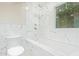 Luxurious bathroom showcasing a white marble tile surround, shower fixtures, and a soaking tub with window at 6102 E Aster Dr, Scottsdale, AZ 85254