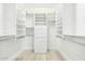 Organized walk-in closet with built-in shelving and drawers for ample storage and convenience at 6102 E Aster Dr, Scottsdale, AZ 85254