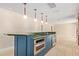 Kitchen island featuring stainless steel appliances, green countertops, and pendant lighting at 6102 E Aster Dr, Scottsdale, AZ 85254
