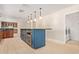 Kitchen island featuring stainless steel appliances and green countertops with laundry room access at 6102 E Aster Dr, Scottsdale, AZ 85254