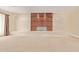 Spacious living area with a modern fireplace and light-colored carpet, perfect for relaxation at 6102 E Aster Dr, Scottsdale, AZ 85254