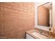 Close up of bathroom with a brick wall and granite vanity at 620 N 4Th Ave # 10, Phoenix, AZ 85003