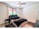 A cozy bedroom with gray walls, a ceiling fan, and a large window letting in natural light at 620 N 4Th Ave # 10, Phoenix, AZ 85003
