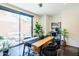A dining area with a wooden table, stylish decor, a workspace, and a sliding glass door to the patio at 620 N 4Th Ave # 10, Phoenix, AZ 85003