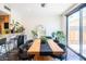 This modern dining area features a wooden table with seating and a sliding glass door to the backyard at 620 N 4Th Ave # 10, Phoenix, AZ 85003