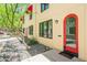 Condo exterior shows a red arched front door, small rock garden and verdant tree at 620 N 4Th Ave # 10, Phoenix, AZ 85003