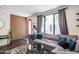 Stylish living room with exposed brick, large sofa, and a view of the entryway at 620 N 4Th Ave # 10, Phoenix, AZ 85003