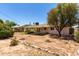 Expansive backyard with desert landscaping, covered patio, and ample space for outdoor activities at 6820 E Pinchot Ave, Scottsdale, AZ 85251