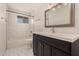 Bathroom with white subway tile tub/shower combination and dark wood vanity at 6820 E Pinchot Ave, Scottsdale, AZ 85251