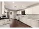 Modern kitchen featuring white cabinetry, stone countertops, and stainless steel appliances at 6820 E Pinchot Ave, Scottsdale, AZ 85251