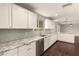 Bright kitchen featuring white cabinets, stainless steel appliances, and granite countertops at 6820 E Pinchot Ave, Scottsdale, AZ 85251