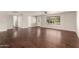 Spacious living room highlighting gleaming hardwood floors, neutral walls, and large windows at 6820 E Pinchot Ave, Scottsdale, AZ 85251