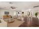 Open-concept living room with hardwood floors, ceiling fan, and comfortable seating at 6820 E Pinchot Ave, Scottsdale, AZ 85251