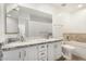 Full bathroom offers double sinks, granite countertop, white cabinets, and large mirror at 7139 W Mcrae Way, Glendale, AZ 85308