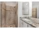 Updated bathroom featuring shower and vanity with granite countertops and bright lighting at 7139 W Mcrae Way, Glendale, AZ 85308