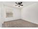 Bedroom featuring neutral carpet flooring, window, and ceiling fan at 7139 W Mcrae Way, Glendale, AZ 85308