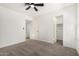 Bedroom with neutral carpet, ceiling fan, and access to walk-in closet and en suite bath at 7139 W Mcrae Way, Glendale, AZ 85308