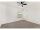 Bedroom with plush neutral carpet, ceiling fan, and window lets in natural light at 7139 W Mcrae Way, Glendale, AZ 85308