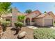 Single-story home featuring a neutral color scheme, desert landscaping, and a red tile roof at 7139 W Mcrae Way, Glendale, AZ 85308