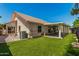 The exterior view shows a well-maintained yard, tiled roof, and covered patio at 7139 W Mcrae Way, Glendale, AZ 85308