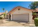 Single-story home featuring a neutral color scheme, a two car garage, desert landscaping, and a red tile roof at 7139 W Mcrae Way, Glendale, AZ 85308