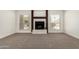 Bright living room featuring a tiled fireplace and carpet flooring at 7139 W Mcrae Way, Glendale, AZ 85308