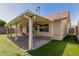 The covered patio features ceiling fans, exterior lighting, and easy access to the grassy yard at 7139 W Mcrae Way, Glendale, AZ 85308