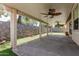 This backyard patio features dual ceiling fans, beautiful stone walls, and synthetic grass at 7139 W Mcrae Way, Glendale, AZ 85308