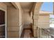 Covered front porch featuring neutral stucco and stone columns plus a secure, white metal gate and tiled floor at 7139 W Mcrae Way, Glendale, AZ 85308
