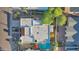 Aerial view of a home featuring a private pool and lush backyard surrounded by mature trees and a light roof at 7610 N Via De Manana Dr, Scottsdale, AZ 85258