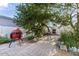 Outdoor dining area and a red ceramic grill surrounded by desert landscaping at 7610 N Via De Manana Dr, Scottsdale, AZ 85258