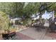 Private backyard oasis with mature trees, stone patio, and outdoor dining area, perfect for entertaining at 7610 N Via De Manana Dr, Scottsdale, AZ 85258