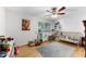 A room featuring a window, wooden floor, rug, crib, and ceiling fan at 7610 N Via De Manana Dr, Scottsdale, AZ 85258