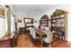 Formal dining room with wood flooring, built-in bookcase, and neutral walls at 7610 N Via De Manana Dr, Scottsdale, AZ 85258