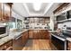 Well-lit kitchen with wood cabinets, granite countertops, and stainless steel appliances at 7610 N Via De Manana Dr, Scottsdale, AZ 85258