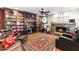 Cozy living room with fireplace, built-in bookshelves, and hardwood flooring at 7610 N Via De Manana Dr, Scottsdale, AZ 85258