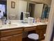 Bathroom featuring dual vanity sinks, white countertops and wood cabinets at 774 E Morningside Dr, Phoenix, AZ 85022